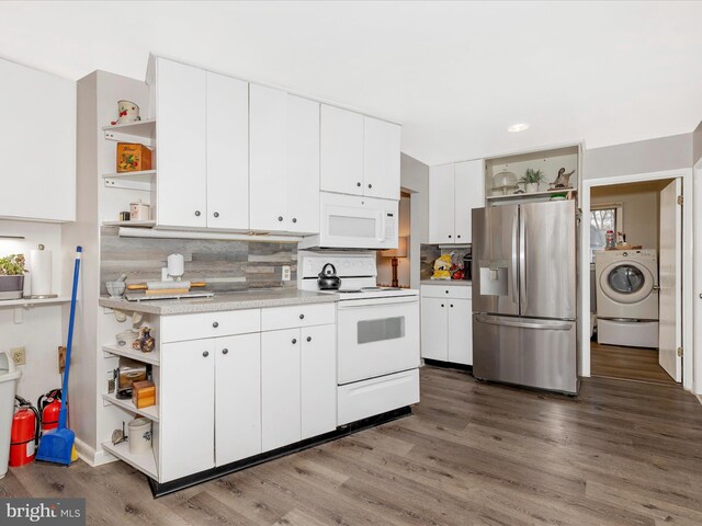 kitchen with open shelves, wood finished floors, white appliances, and washer / clothes dryer