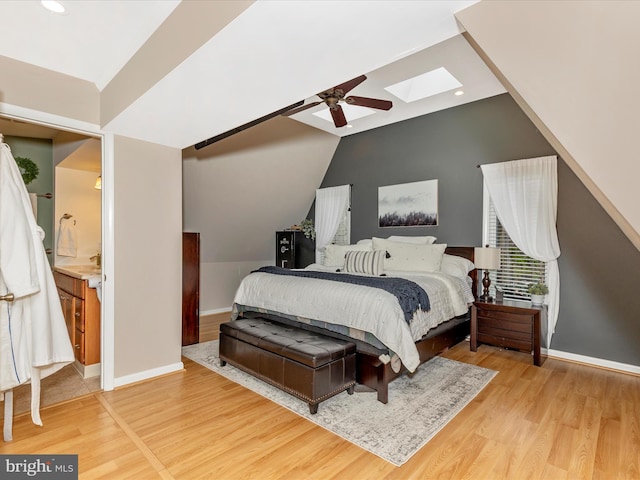 bedroom with recessed lighting, lofted ceiling with skylight, baseboards, light wood-style flooring, and ceiling fan
