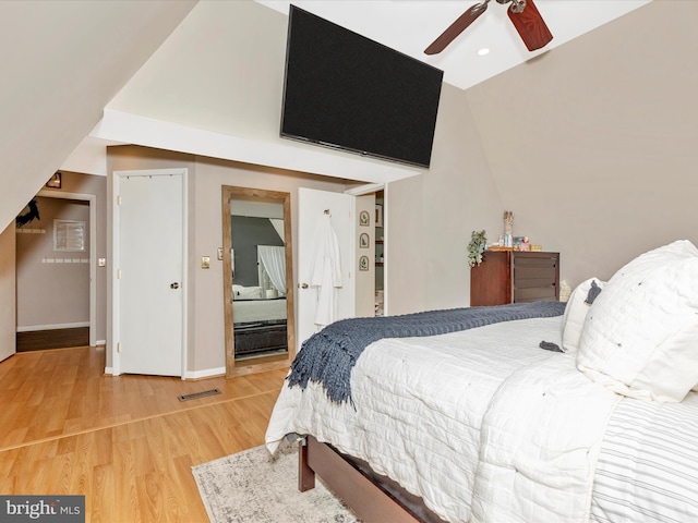 bedroom featuring light wood finished floors, baseboards, visible vents, and ceiling fan