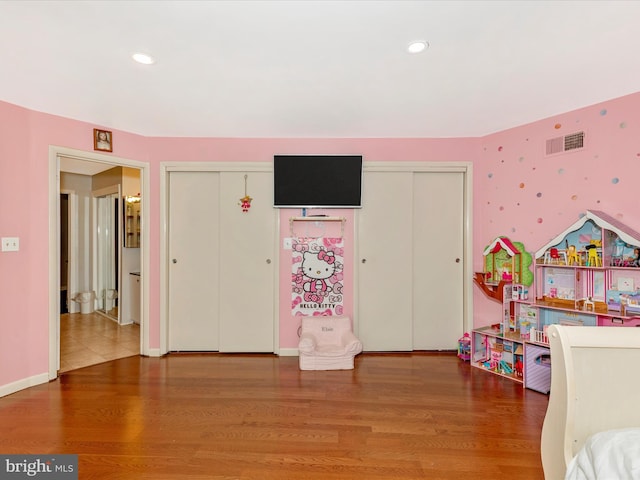 bedroom featuring recessed lighting, wood finished floors, and visible vents