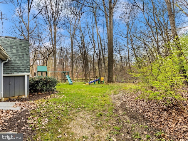 view of yard featuring a storage shed and a playground