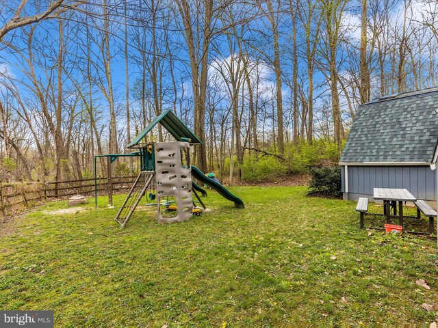 view of yard with a playground and fence