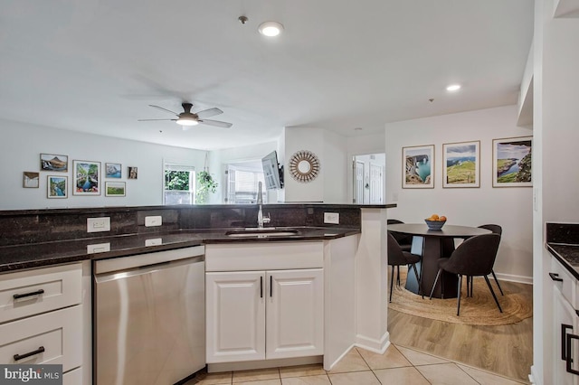 kitchen with dishwasher, a sink, white cabinetry, a ceiling fan, and light tile patterned flooring