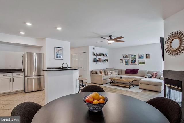 living room featuring ceiling fan, light tile patterned floors, and recessed lighting