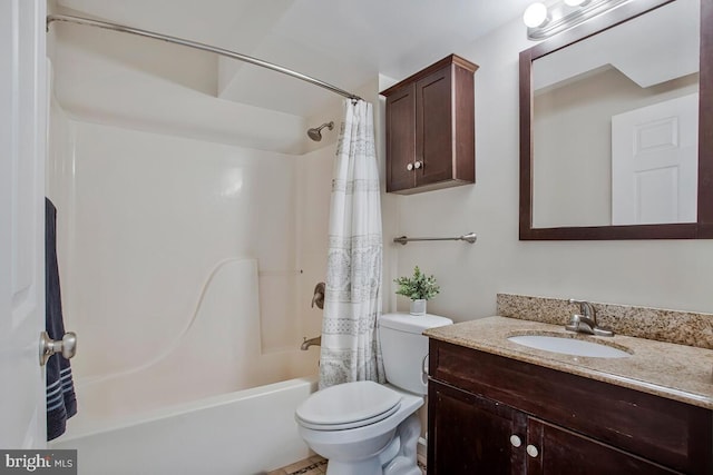 full bathroom with vanity, shower / tub combo, and toilet