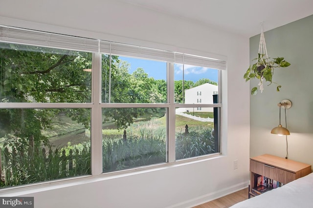 bedroom with wood finished floors and baseboards