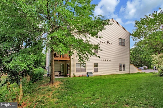 rear view of property with a yard