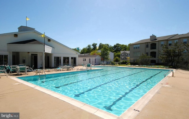 community pool featuring a patio area and fence