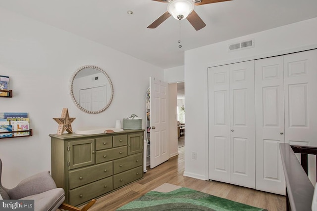 bedroom with light wood finished floors, a closet, and ceiling fan
