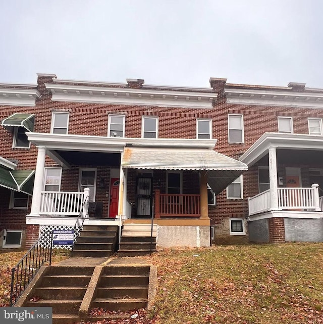 2328 W Lexington St, Baltimore, MD 21223 - view of front facade featuring covered porch and brick siding