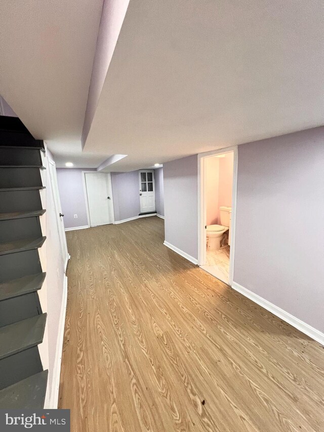 2328 W Lexington St, Baltimore, MD 21223 - finished basement with wood finished floors, baseboards, and stairway
