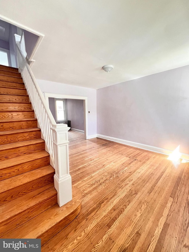 2328 W Lexington St, Baltimore, MD 21223 - stairway featuring baseboards and wood finished floors