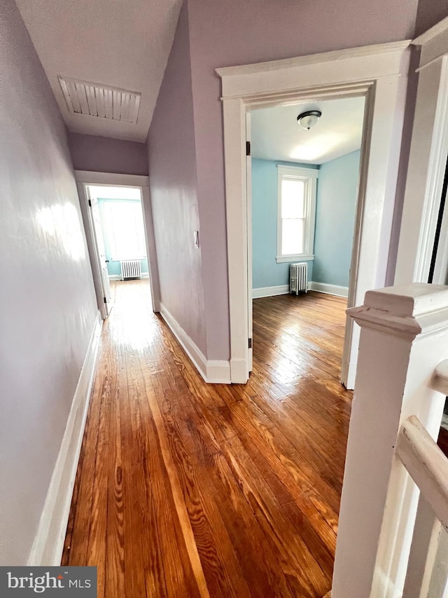 2328 W Lexington St, Baltimore, MD 21223 - corridor with radiator, wood finished floors, visible vents, and baseboards