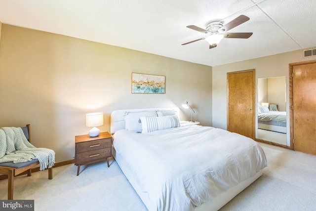bedroom featuring light colored carpet, ceiling fan, baseboards, and visible vents