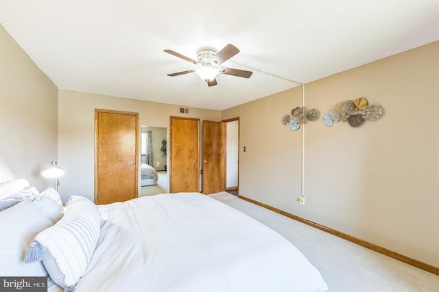 carpeted bedroom featuring ceiling fan, baseboards, and visible vents