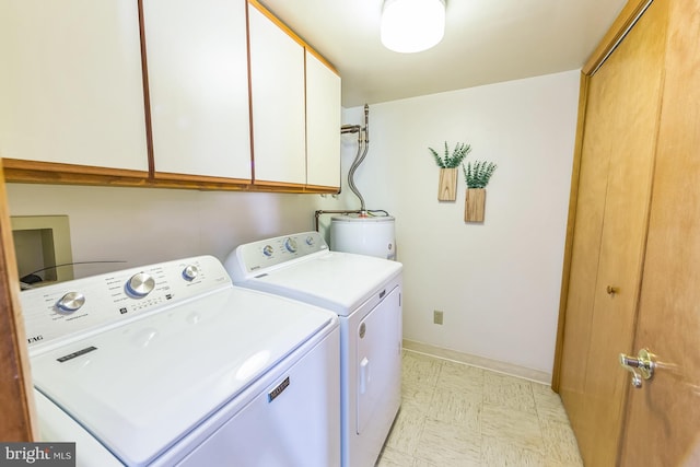 laundry room with separate washer and dryer, light floors, water heater, cabinet space, and baseboards