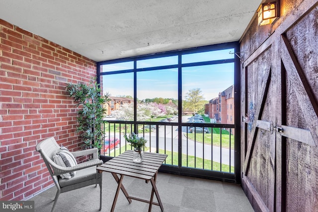 sunroom featuring a residential view and plenty of natural light