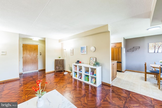 interior space with baseboards and a textured ceiling