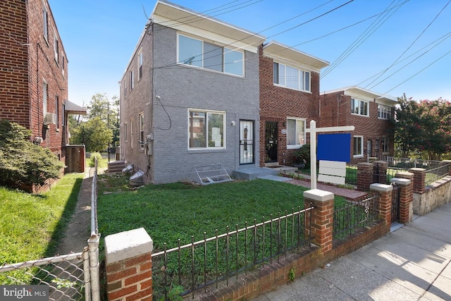 view of front of property with brick siding, a front yard, and fence