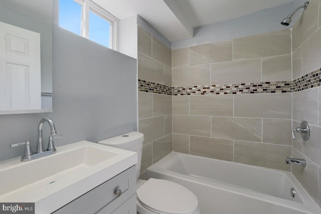 bathroom with toilet, vanity, and shower / washtub combination