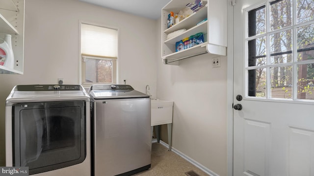 washroom with baseboards, light carpet, visible vents, laundry area, and washer and dryer