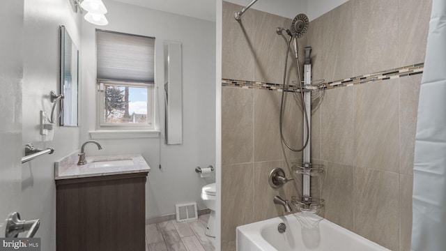 full bathroom with vanity, baseboards, toilet, shower / bathtub combination, and visible vents