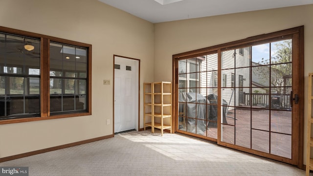 doorway to outside with ceiling fan, baseboards, and carpet floors