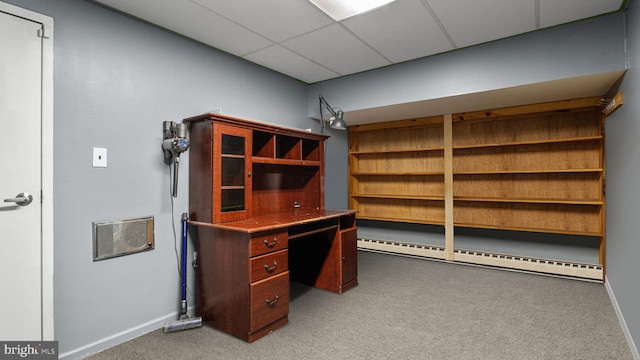 unfurnished office featuring baseboard heating, light carpet, baseboards, and a drop ceiling