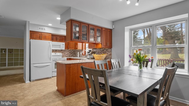 dining area featuring visible vents and light floors