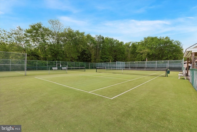 view of tennis court featuring fence