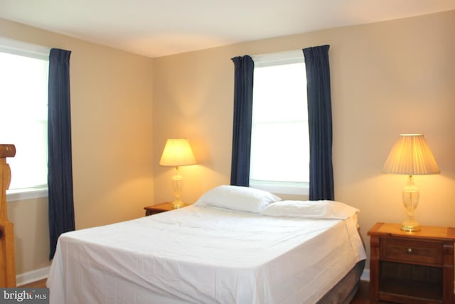 bedroom featuring wood finished floors and baseboards