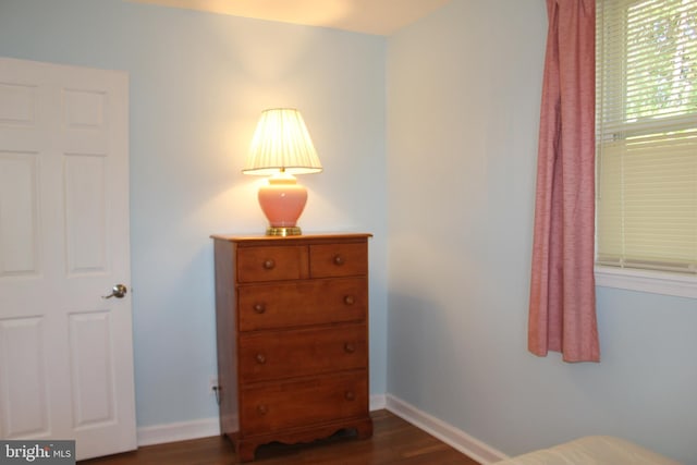 bedroom featuring dark wood-style flooring and baseboards