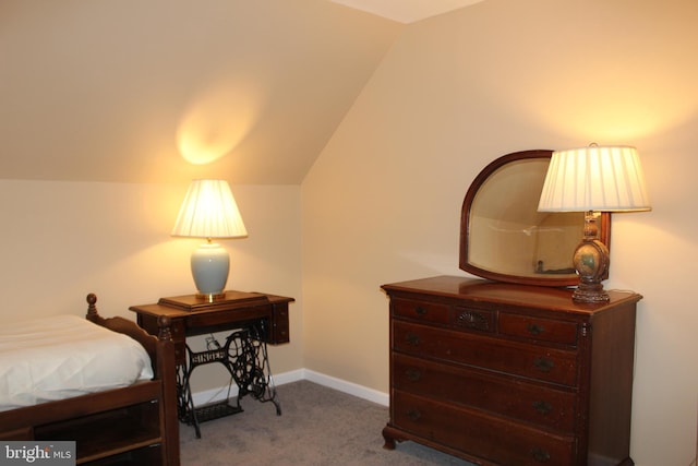 carpeted bedroom featuring vaulted ceiling and baseboards