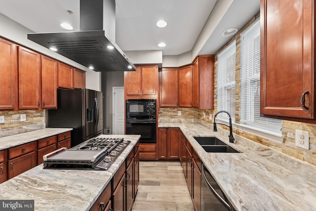 6319 Seton Ridge Dr, Baltimore, MD 21207 - kitchen featuring island exhaust hood, light stone counters, light wood-style flooring, black appliances, and a sink