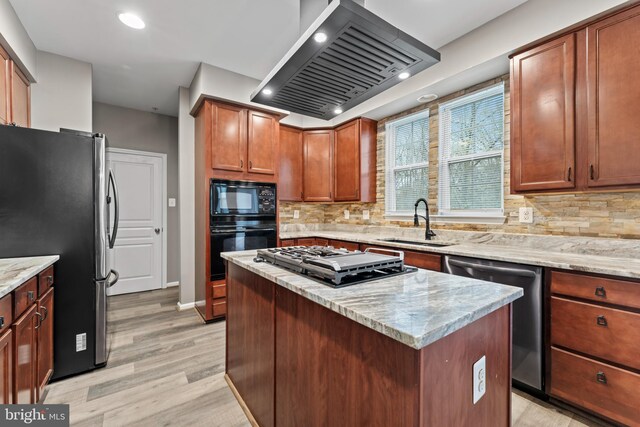6319 Seton Ridge Dr, Baltimore, MD 21207 - kitchen with a kitchen island, black appliances, extractor fan, light wood finished floors, and a sink