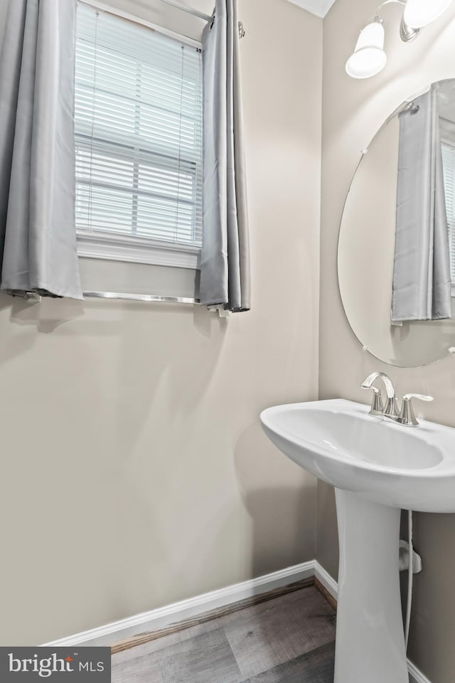 6319 Seton Ridge Dr, Baltimore, MD 21207 - bathroom with baseboards, a sink, and wood finished floors