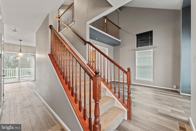 6319 Seton Ridge Dr, Baltimore, MD 21207 - stairs with a high ceiling, wood finished floors, baseboards, and visible vents