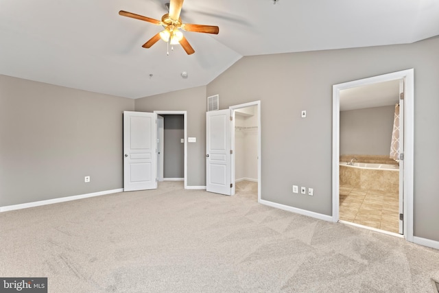 6319 Seton Ridge Dr, Baltimore, MD 21207 - unfurnished bedroom with visible vents, baseboards, a walk in closet, vaulted ceiling, and carpet flooring