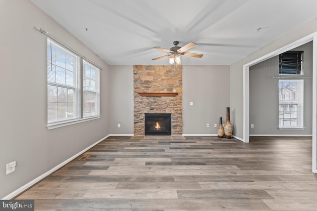 6319 Seton Ridge Dr, Baltimore, MD 21207 - unfurnished living room featuring baseboards, a fireplace, a ceiling fan, visible vents, and wood finished floors