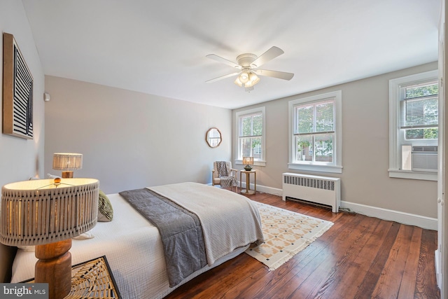179 Green St, Annapolis, MD 21401 - bedroom featuring radiator, multiple windows, wood finished floors, and cooling unit