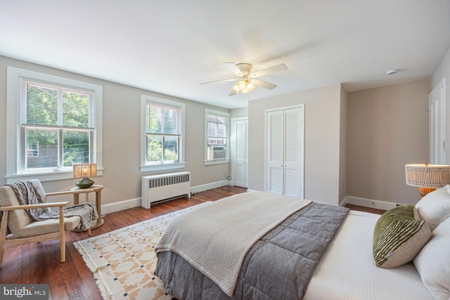 179 Green St, Annapolis, MD 21401 - bedroom featuring radiator, wood finished floors, baseboards, multiple closets, and a ceiling fan