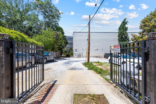 179 Green St, Annapolis, MD 21401 - view of asphalt driveway with a gate, a gated entry, and a water view