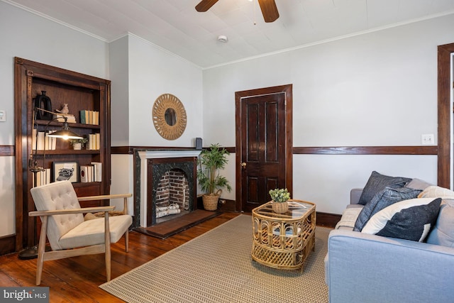 179 Green St, Annapolis, MD 21401 - living area with crown molding, wood finished floors, ceiling fan, and a fireplace with raised hearth
