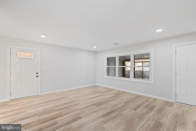interior space with light wood-type flooring, baseboards, and recessed lighting