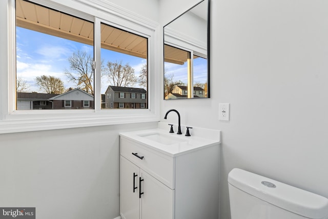 bathroom with toilet and vanity