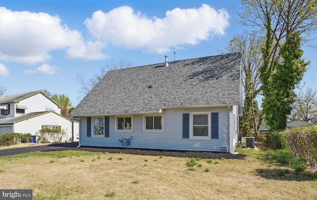 rear view of property with a yard, fence, central AC, and roof with shingles