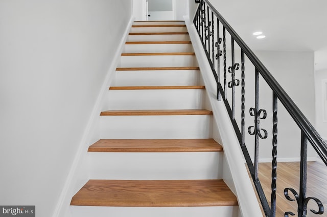 stairway featuring wood finished floors