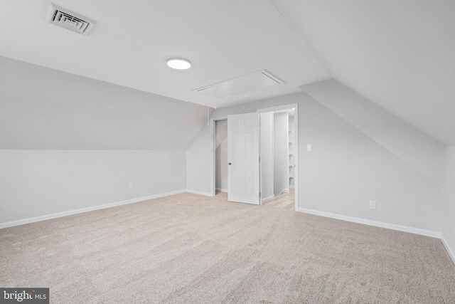 bonus room with visible vents, attic access, carpet flooring, and vaulted ceiling