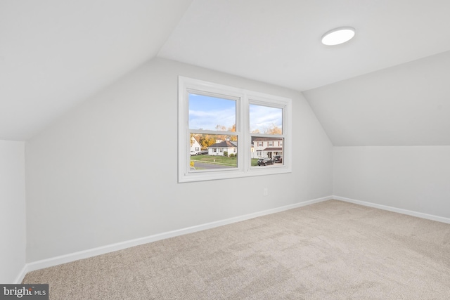 bonus room with carpet flooring, baseboards, and lofted ceiling