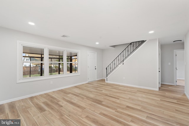 unfurnished living room with recessed lighting and light wood-style floors